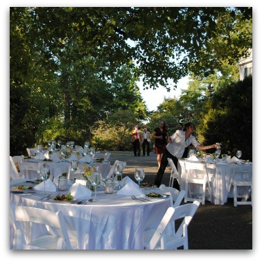 Dinner is served family style at elegantly appointed tables under the lights